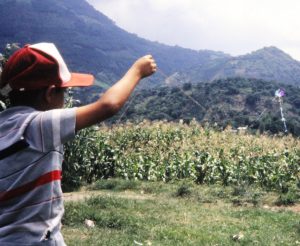 guatemalan-boy-flying-kite-near-cornfield