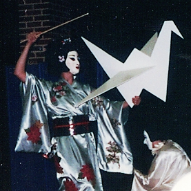actor with large paper crane